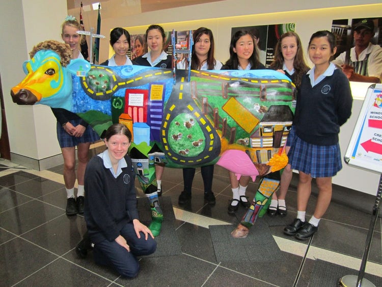 Students with painted cow